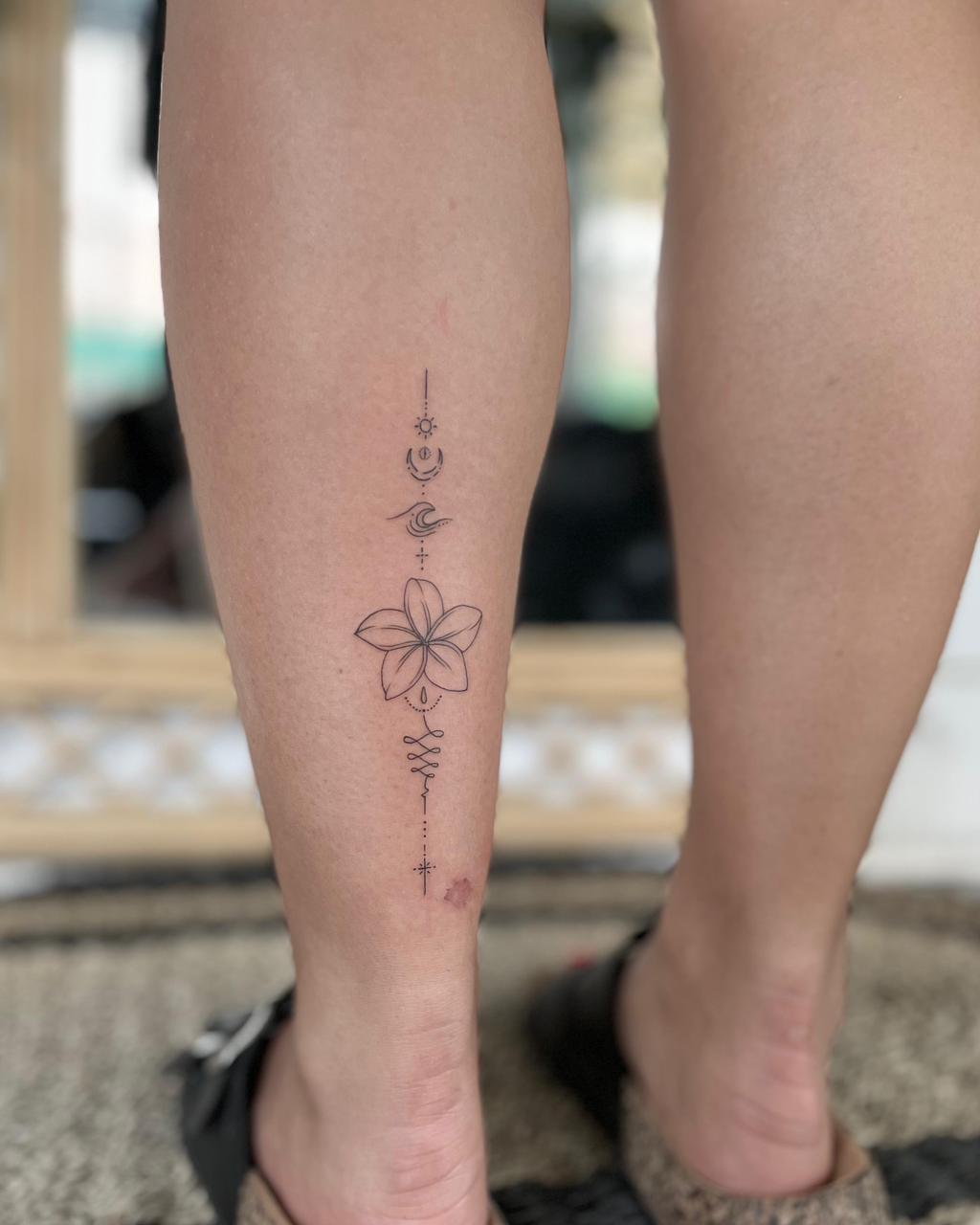 Fine line spine lettering tattoo - Tropical Ink Bali
